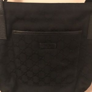 Gently used Gucci black canvas messenger bag.
